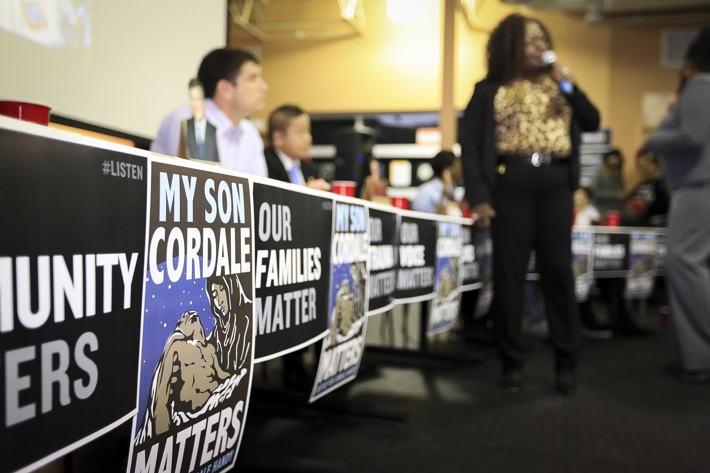 Posters by Leon Wang at a community meeting after the officer-involved killing of Cordale Handy in Saint Paul